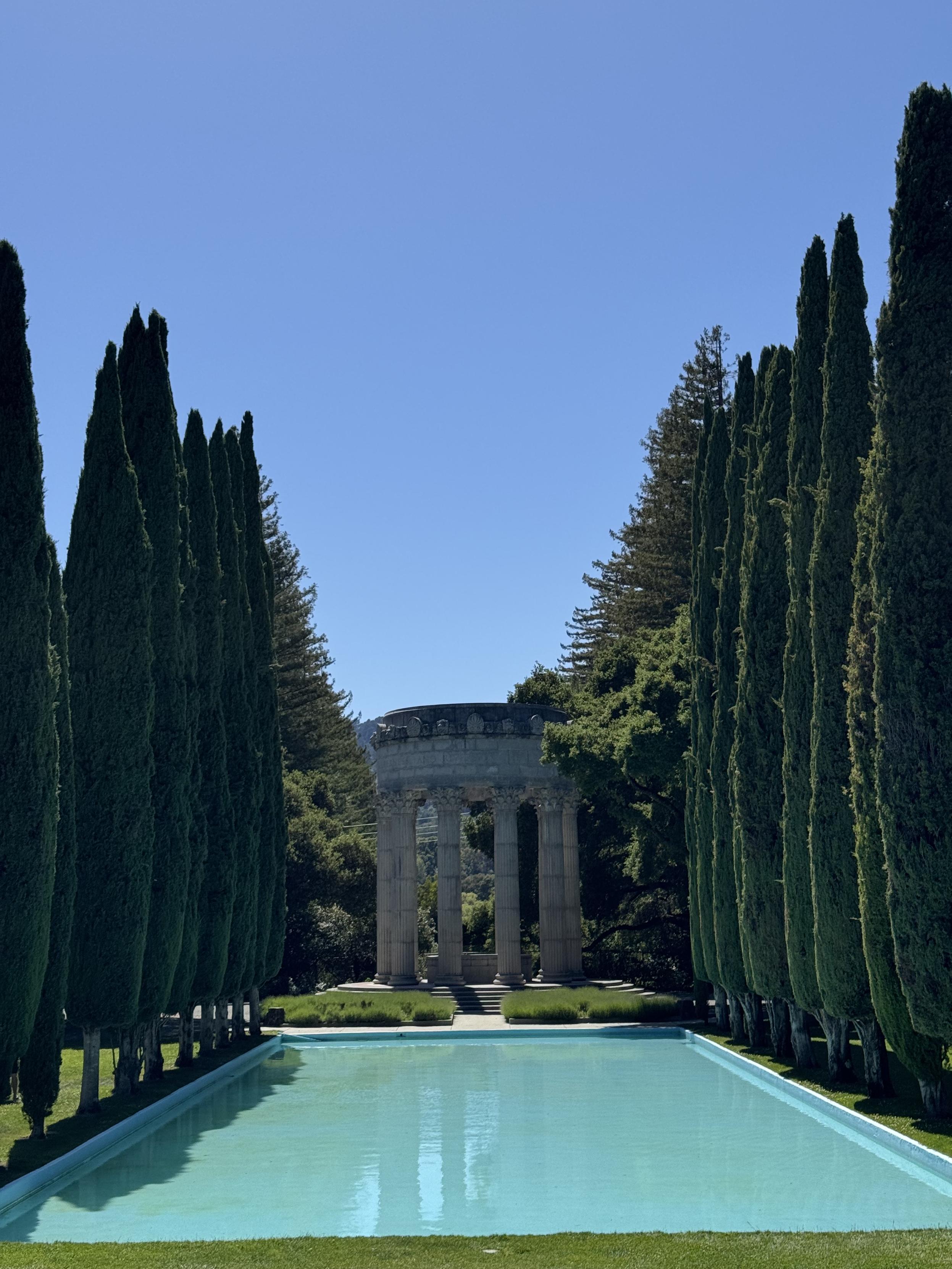 photograph of the pulgas temple, a (pasting from wikipedia) a circle of fluted Corinthian columns surmounted by a large masonry ring bearing the inscription "I give waters in the wilderness and rivers in the desert, to give drink to my people" [from Isaiah 43:20]. There is a reflecting pool lined with cypress trees.