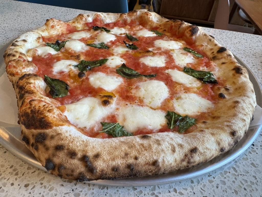 close up, another margherita pizza, this one was shaped on wheat flour and has pecorino romano cheese as well