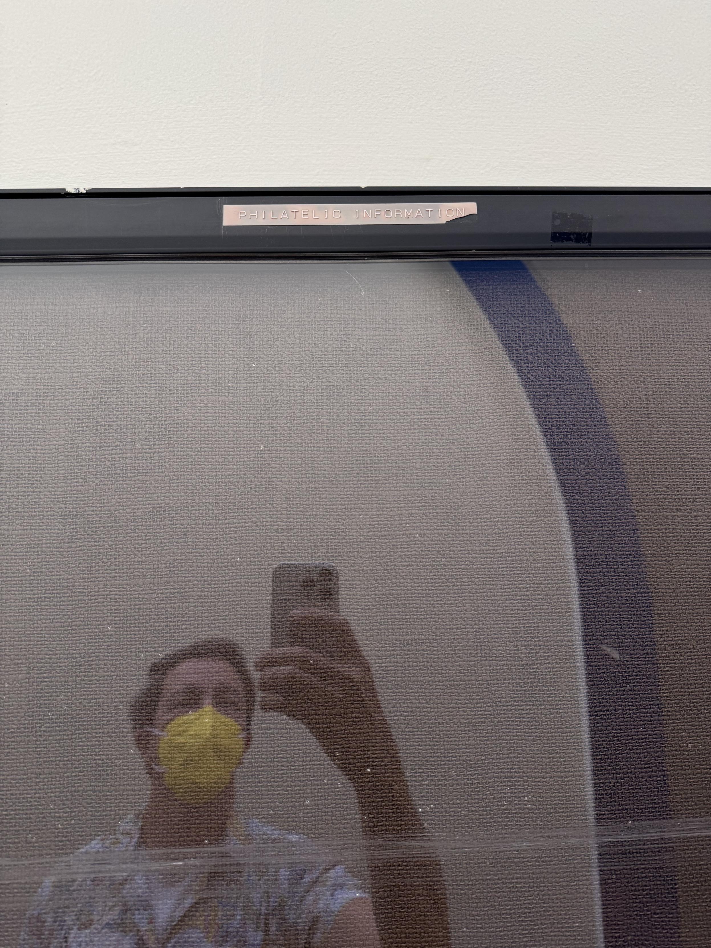 selfie, man wearing a yellow kn95 mask reflected in the glass of an empty notice board with a sign on top proclaiming: PHILATELIC INFORMATION