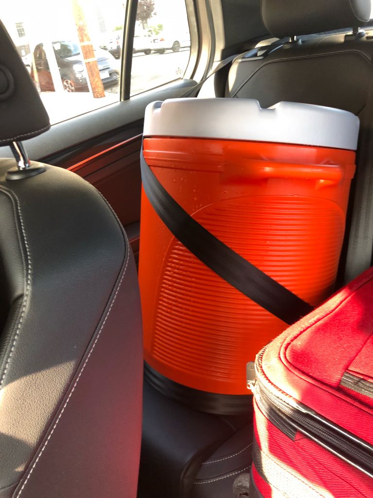 Water cooler seat-belted into the back seat.