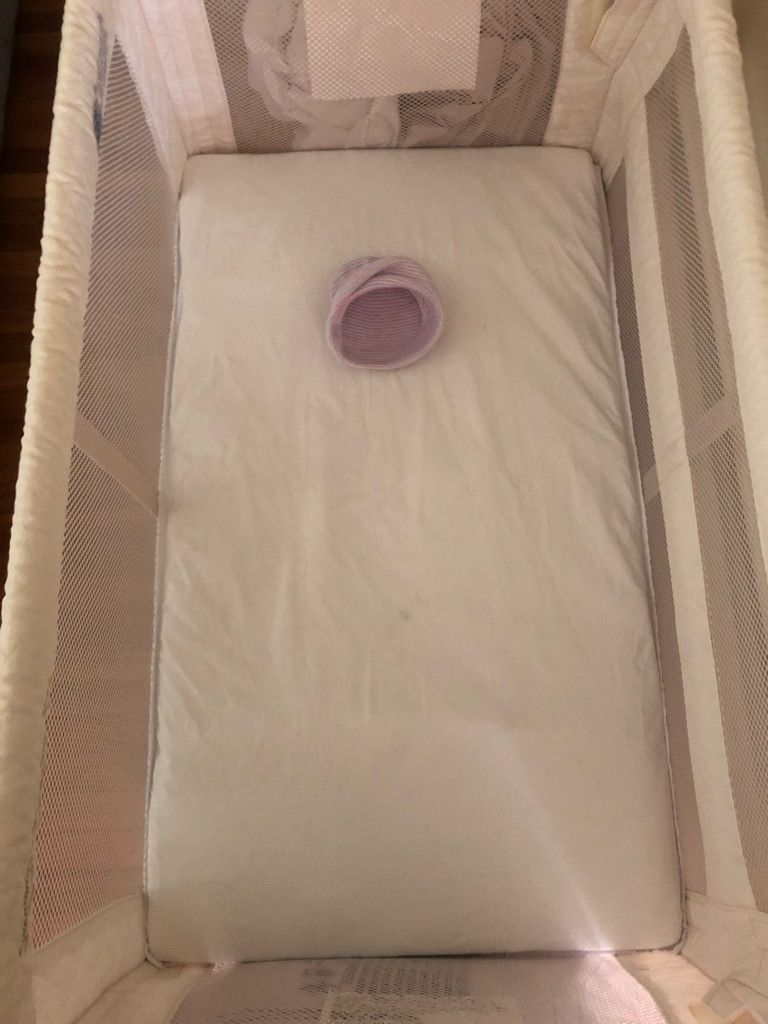 An empty hat in a bassinet.