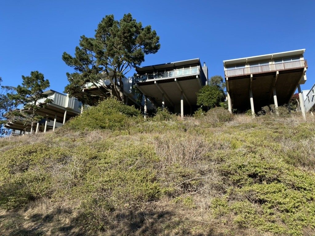 houses cantilevered on 40 foot pillars as seen from below in glen canyon