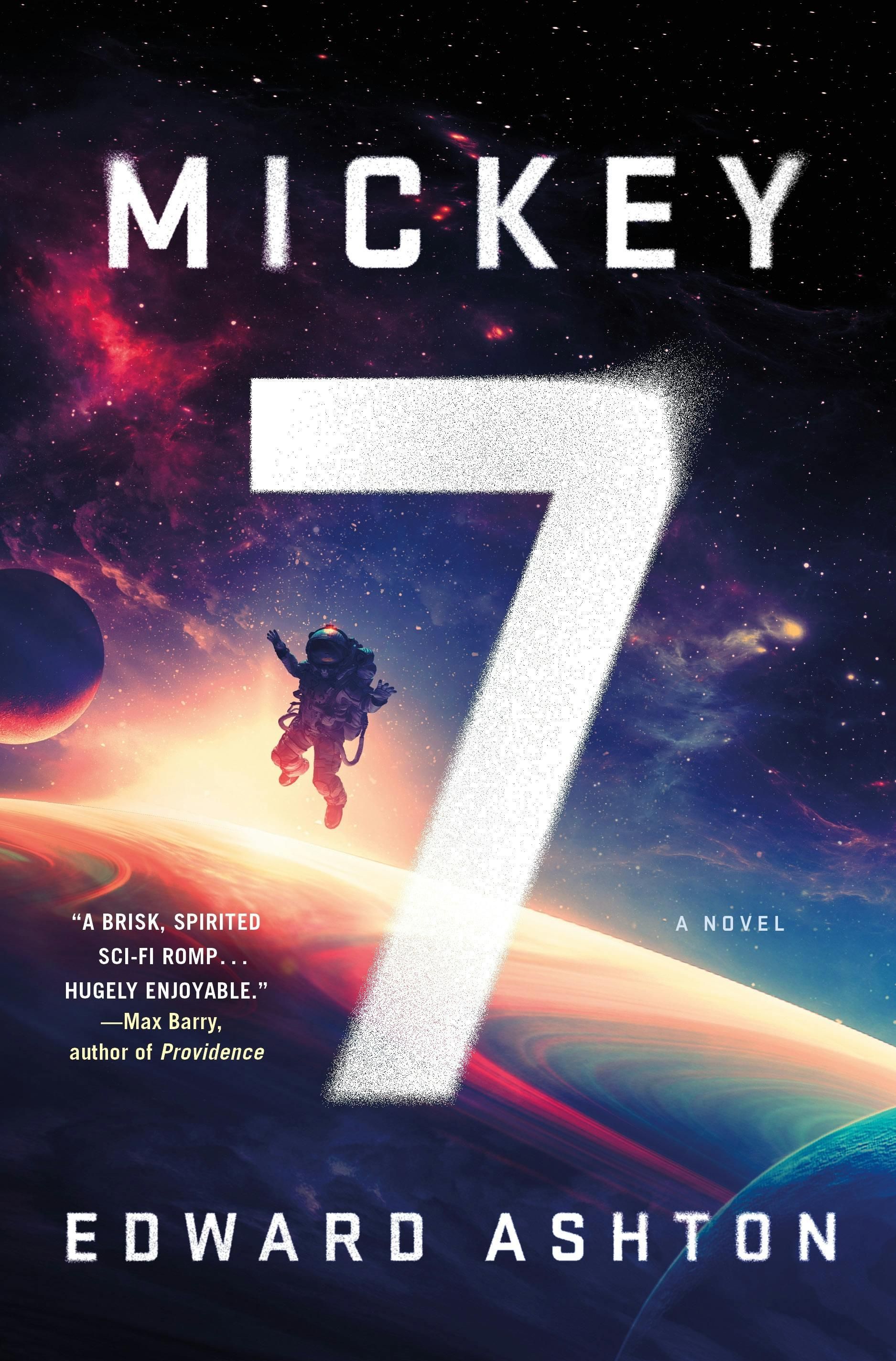 The cover of Mickey7 on paperback, as I read it (almost, I got my copy far enough along that it has “soon to be a major motion picture” on it too)An astronaut is on a spacewalk over a ringed gas giant w/ a nondescript moon over a mostly dark nebula filled star field (which has nothing to do with the story and is kinda hokey but “look at me I’m Science Fiction” gets the job done I guess. The title “MICKEY” is in white along the top with a particle effect that everyone seems to be doing (which makes sense on like, 4k+ TVs to show off but otherwise is just kinda a sand look or snow? idk), while in the center taking half the height of the cover is the number 7, author name in smaller print along the bottom.
