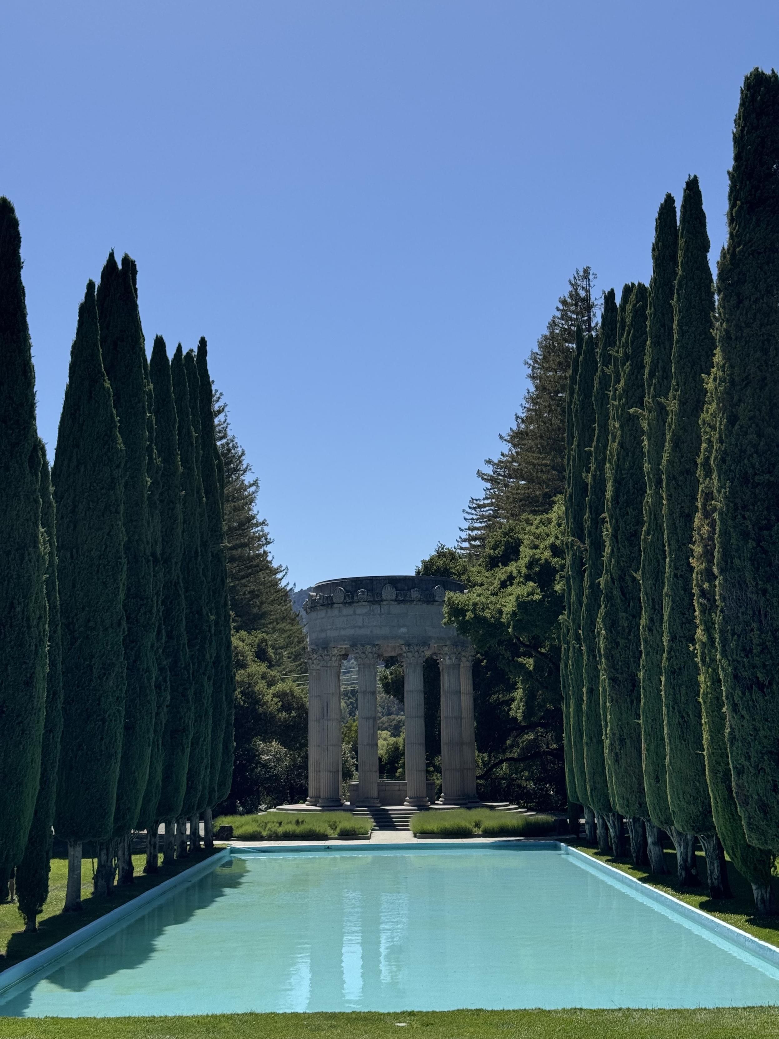 photograph of the pulgas temple, a (pasting from wikipedia) a circle of fluted Corinthian columns surmounted by a large masonry ring bearing the inscription "I give waters in the wilderness and rivers in the desert, to give drink to my people" [from Isaiah 43:20]. There is a reflecting pool lined with cypress trees.