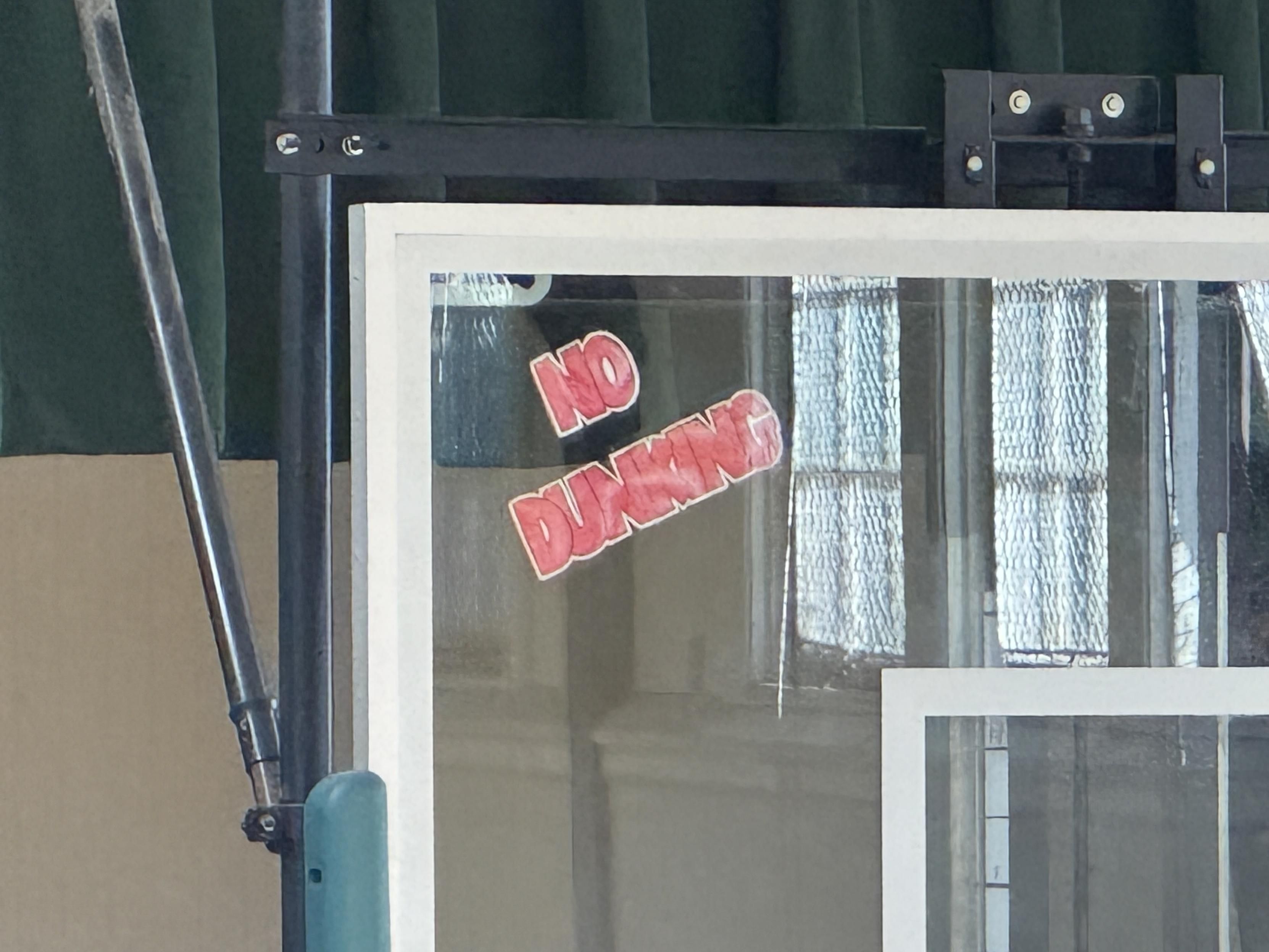 ECU, one of the signs, red colored-in matter, all caps on white paper:NODUNKING